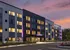 Luxor Montgomeryville's modern apartment building with purple lights and