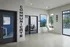Lounge with private offices, a hanging bubble chair, abstract art, and large windows with a view of the courtyard