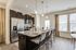 furnished kitchen area with island in townhome