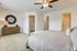 furnished bedroom with ceiling fan in townhome
