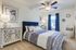 furnished bedroom with ceiling fan in townhome