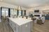 furnished clubroom area with kitchen island and seating