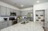furnished kitchen with island of home