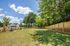 outdoor pet park with grassy field and fence on sunny day