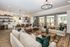 furnished clubroom with seating and kitchen