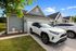 exterior sunny day vehicles parked in drive way
