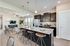 Modern Kitchen with dark wood cabinetry, stainless steel appliances, and island in Spartanburg, SC apartment