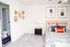 Furnished carpeted bedroom leading into private bathroom