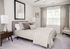 Main bedroom with plush carpeting and natural lighting
