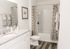 Bathroom with white cabinetry and vinyl plank flooring and shower tub