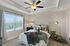 Bedroom with carpet, ceiling fan, and window