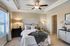 Bedroom with carpet, ceiling fan, and window
