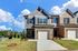 Townhome with attached garage and paved driveway