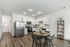 Open Kitchen with Stainless Steel Appliances and White Cabinetry