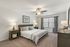 Large Primary Bedroom with Ceiling Fan and Plush Carpeting