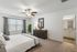 Large Primary Bedroom with Ceiling Fan and Plush Carpeting