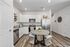 Kitchen with white cabinets, granite countertops, stainless steel appliances