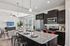 Contemporary kitchen and living area with modern appliances, elegant granite countertops, and stylish decor, perfect for entertaining.