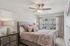 Bright and inviting bedroom with a plush bed, stylish decor, and large window offering scenic views, creating a serene and comfortable atmosphere.
