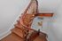 Elegant staircase with polished wooden banister leading to bright entrance, offering charm and character.
