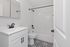 Elegant bathroom design featuring sleek black fixtures, patterned tile flooring, and a modern vanity, creating a serene retreat.