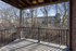 Inviting balcony with scenic wooded view, perfect for relaxation and enjoying nature.