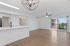 Bright open-concept living area with hardwood floors, modern fixtures, and balcony access.