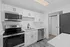 Modern kitchen featuring sleek stainless steel appliances, elegant white cabinetry, and stylish tiled flooring.