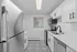 Sleek modern kitchen with stainless steel appliances, white cabinetry, and patterned tile flooring.