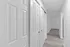 Bright hallway with sleek sliding closet doors and modern wood flooring.