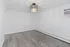 Bright room with elegant wood flooring, modern chandelier, and built-in air conditioning unit, ideal for customizable interior design.