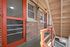 Charming brick apartment exterior with bright orange accents and staircase, featuring vintage windows.