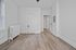 Bright and inviting room with light wood flooring and classic white radiator, perfect for a cozy living space.