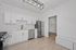 Bright modern kitchen with sleek stainless steel appliances, elegant white cabinetry, and chic pendant lighting, offering a stylish and functional cooking space.