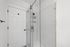 Elegant modern bathroom with a sleek glass shower enclosure and white subway tile, maximizing style and functionality.