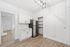 Modern kitchen space with sleek stainless steel appliances, chic white cabinetry, and stylish lighting, perfect for culinary creativity.