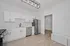 Modern kitchen with sleek stainless steel appliances, white cabinetry, and elegant light fixture, perfect for gourmet cooking.