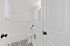 Elegant bathroom featuring a classic white bathtub, modern vanity, and chic black-and-white patterned floor tiles.
