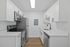 Modern kitchen with sleek stainless steel appliances, white cabinetry, and elegant countertops, offering a stylish and functional space for cooking.