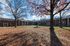 Beautiful apartment complex featuring classic red brick buildings surrounded by autumn trees and a serene courtyard.