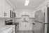Modern kitchen featuring sleek stainless steel appliances, elegant white cabinetry, and stylish marble countertops.