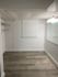 Bright and versatile room with elegant lighting and modern flooring, perfect for storage or a cozy office nook.