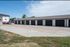 Spacious parking area with individual garage units in a modern apartment community.