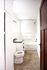 Bright and spacious bathroom featuring a modern design with a sleek bathtub, elegant tile flooring, and ample storage.