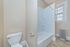 Bright and inviting bathroom with modern tub-shower combo and natural light from a frosted window.