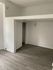 Bright and modern apartment corner with wood flooring, featuring a cozy nook and entryway.