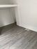 Chic and modern room with sleek gray laminate flooring, perfect for a cozy and stylish space.