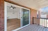 Inviting balcony view showcasing a modern, stylish living area with elegant lighting and chic wood flooring.