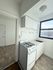 Charming kitchen with a classic white stove, ample cabinetry, and a bright window offering a warm and inviting atmosphere.