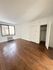 Bright room with elegant wooden floors, large window, and cozy closet space.